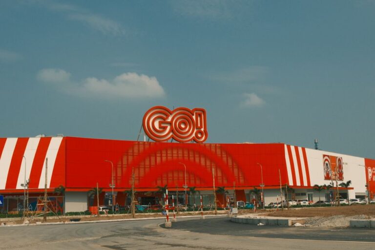 Dynamic view of the GO Shopping Center in Nam Dinh, Vietnam, showcasing its vibrant red and white facade.